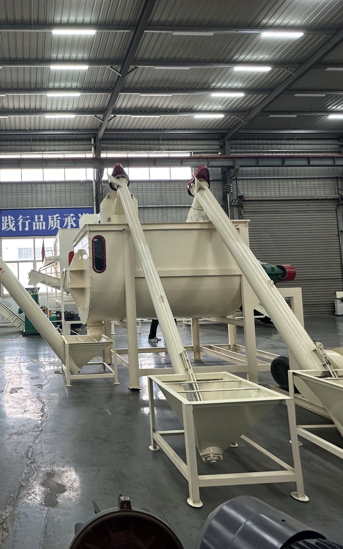 Diesel-powered flat-die feed pellet mill on a wheeled frame in the SIDIO workshop